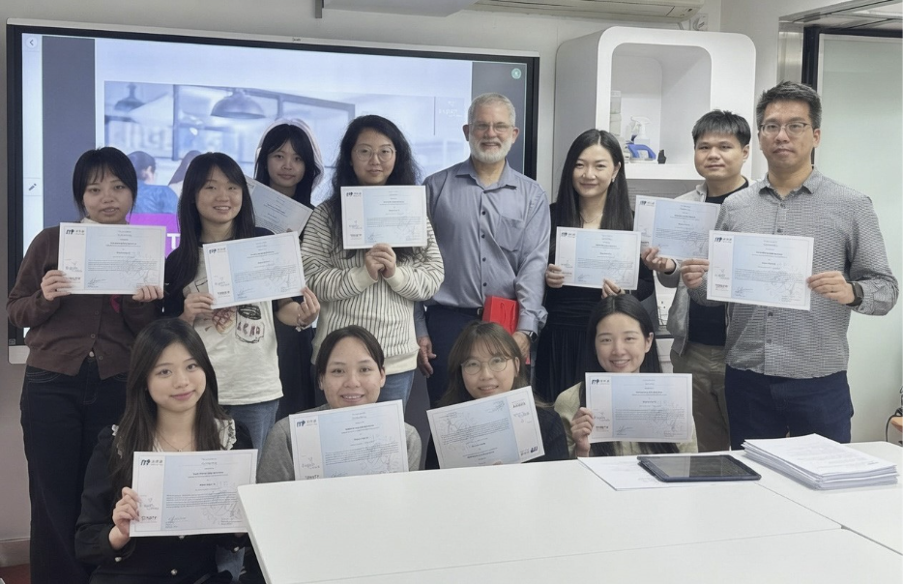 A group of workshop attendees holding certificates